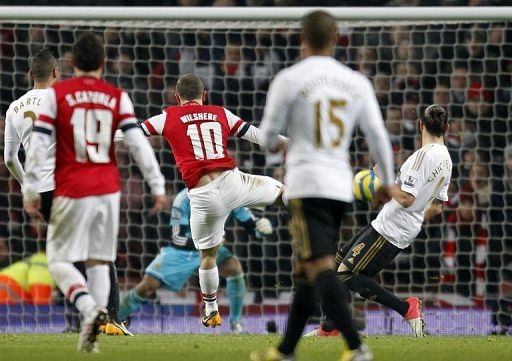Wilshere late show keeps Gunners' Cup bid going
