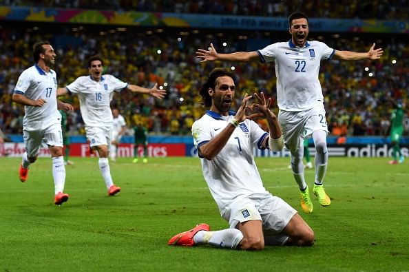 Greece convert debatable injury time penalty to defeat Ivory Coast 2-1; reach knockout stages for the first time