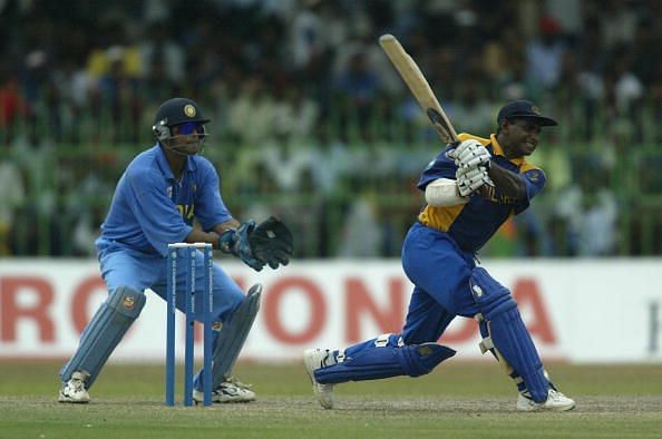 Sanath Jayasuriya of Sri Lanka on his way to a half century watched by Rahul Dravid of India