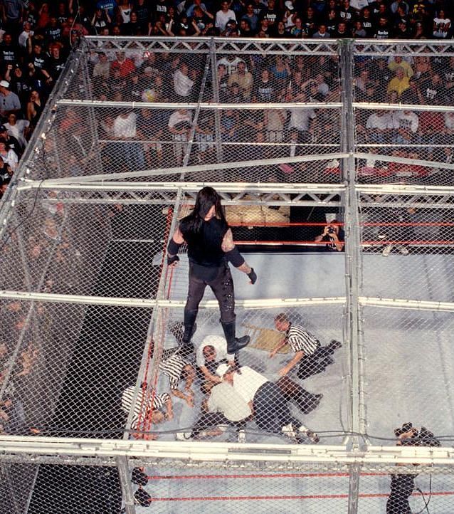 The Undertaker looks on as Mankind is checked on by personel