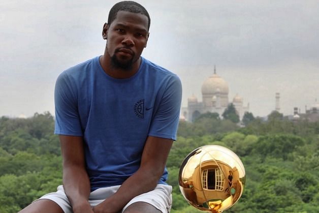 Kevin Durant with the NBA Championship trophy at Agra with the Taj Mahal in the background. Image Source: NBA India