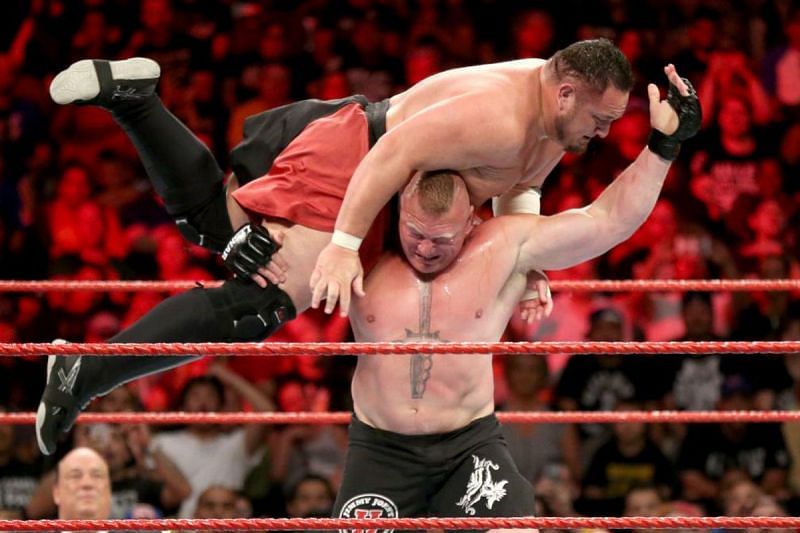 Samoa Joe on the shoulders of Brock Lesnar