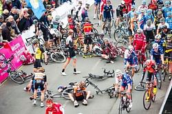 Video: Race sees multi-cycle pileup after rider hits parked car