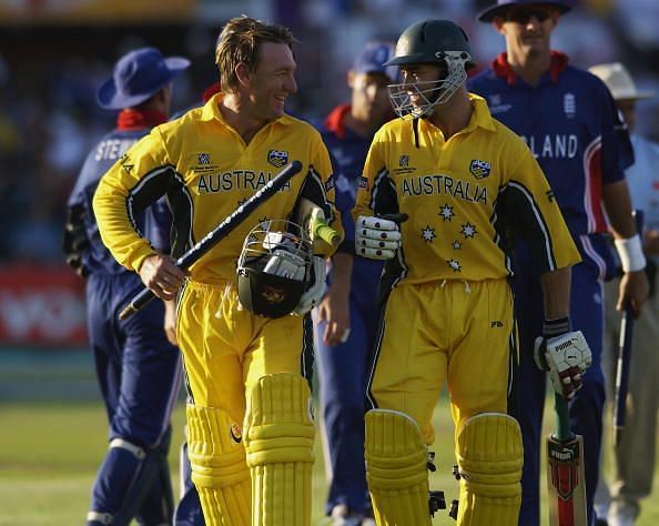Michael Bevan and Andy Bichel of Australia walk back to the pavilion
