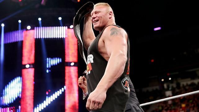 Brock Lesnar lifting the WWE title in the ring on RAW