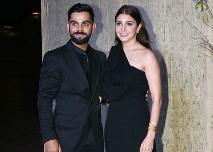 Virat and Anushka pose for pictures at a party