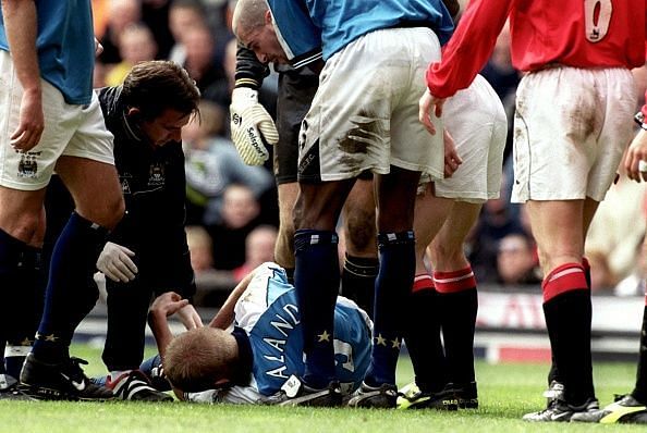 Alf Inge Haaland receives treatment after being poleaxed by Roy Keane