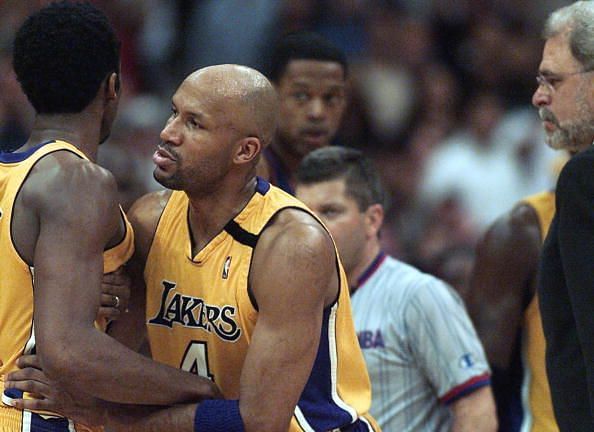 Kobe Bryant is restarined by his teammate after an altercation with Childs