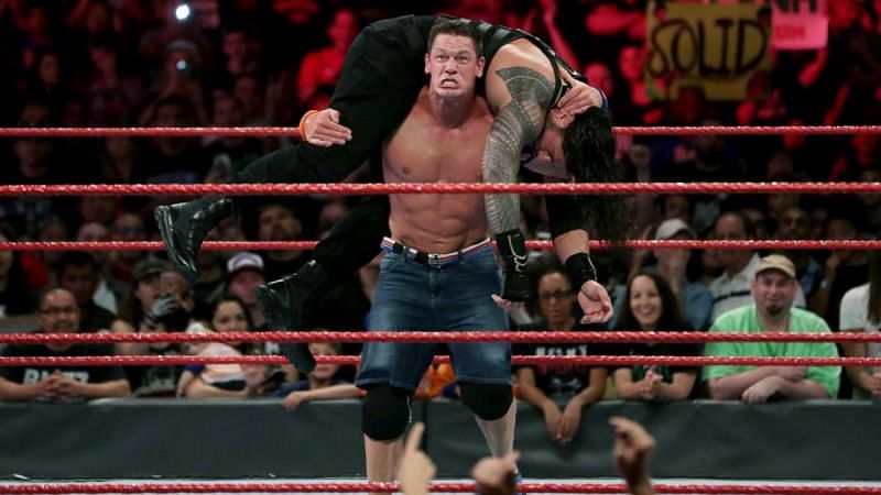 Cena with one of four Attitude Adjustments to Roman Reigns