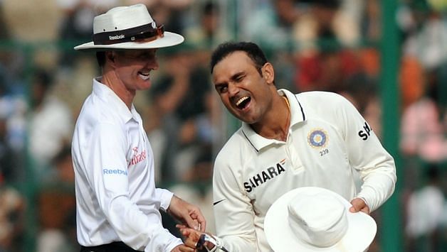 Sehwag enjoys a light moment with umpire Billy Bowden