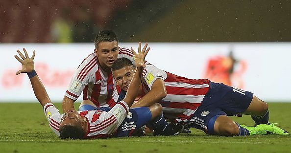 The Paraguayan players celebrate after beating Mali
