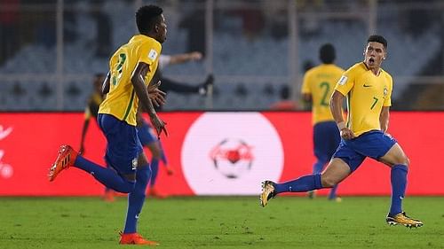 Paulinho wheels away in celebration after scoring Brazil's winner