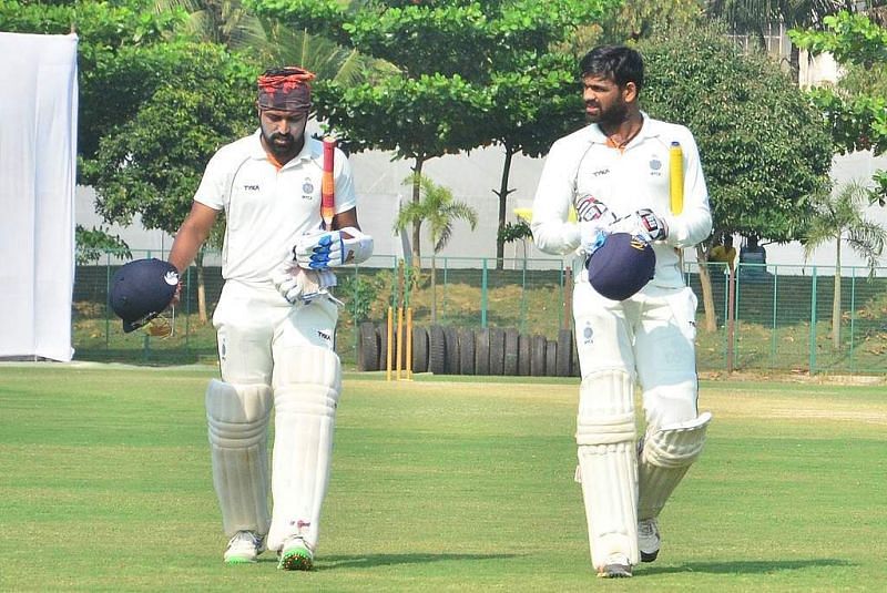 Shubham Sharma (left) walks back to the pavilion after the end of a session
