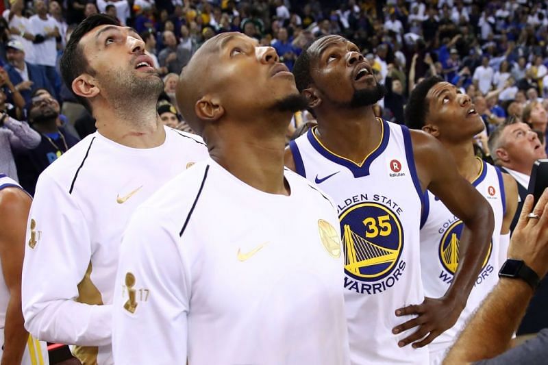 Warriors players look on during the replay review of the final shot