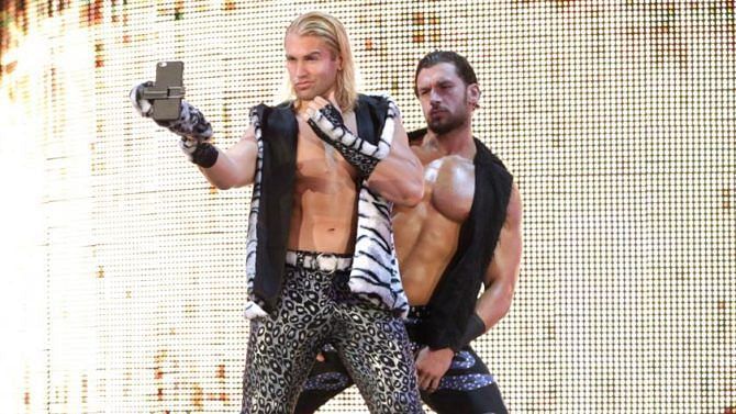 Breezango, looking at pictures of their nearest and dearest.
