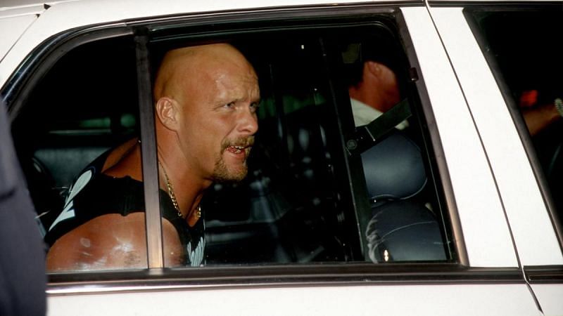 Stone Cold being carted away in a police car
