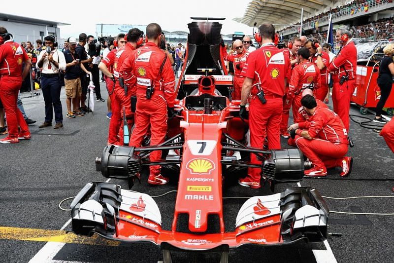 Ferrari engineers working on Kimi Raikkonen&#039;s car at the grid