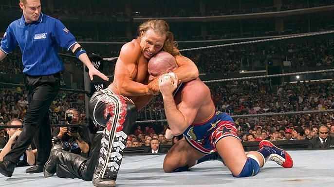 Shawn Michaels slaps a headlock on Kurt Angle