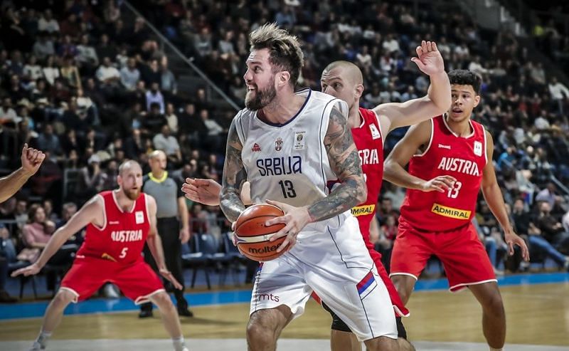 Serbia&#039;s Miroslav Raduljica (13) drives to make a basket against Austria.