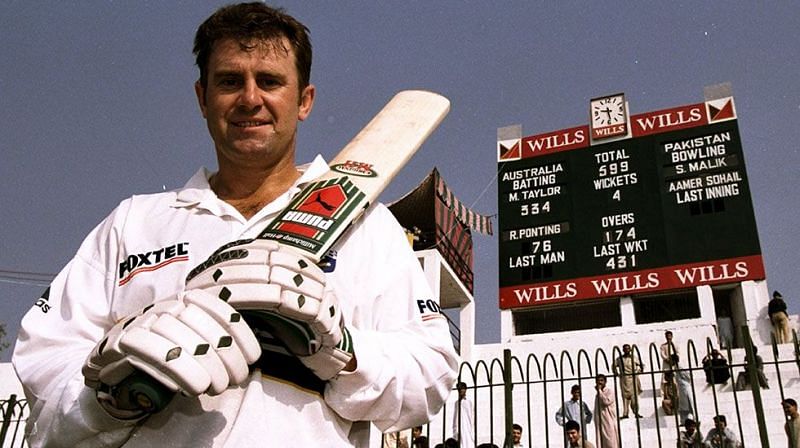 Mark Taylor poses in front of the scorecard after scoring 334