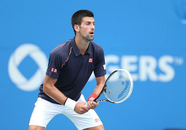 Djokovic appears to wait with his right hand in a relatively neutral grip in between his forehand grip and his backhand grip