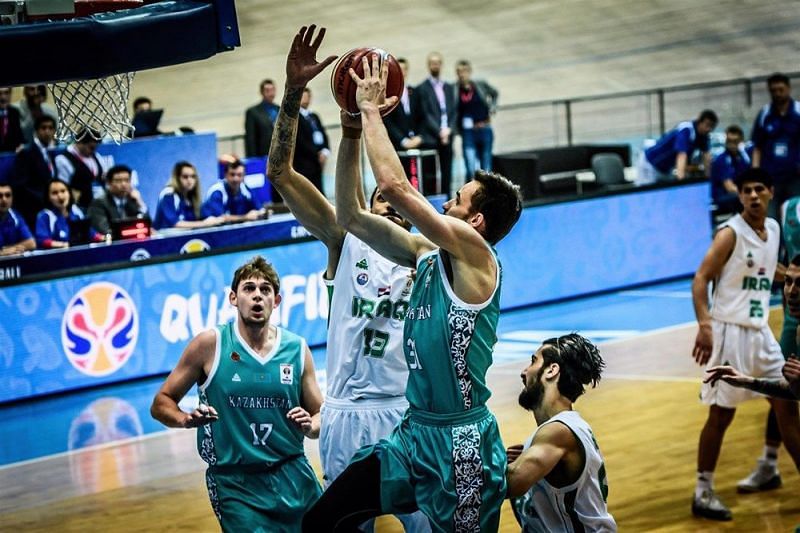 Kazakhstan&#039;s Anatoliy Kolesnikov (31) drives to the basket in the OT win against Iraq.