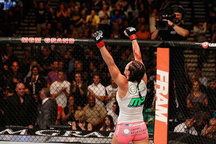 Zingano raises her arms in victory