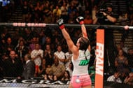 Zingano raises her arms in victory