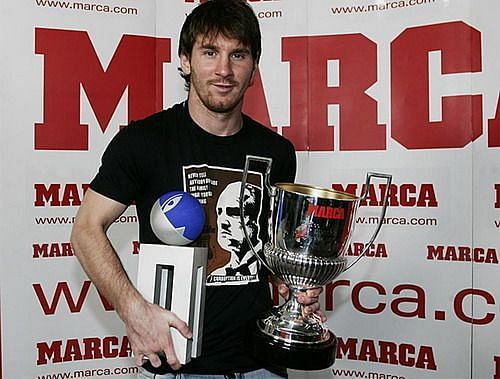 Lionel Messi holding aloft one of his Pichichi trophies (left)