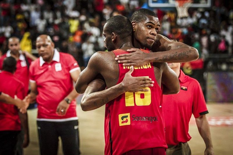 Two Angolan players breathe a sigh of relief after a comeback victory against Egypt.