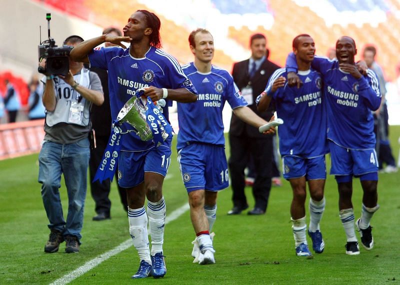 Didier Drogba holds the trophy his goal won