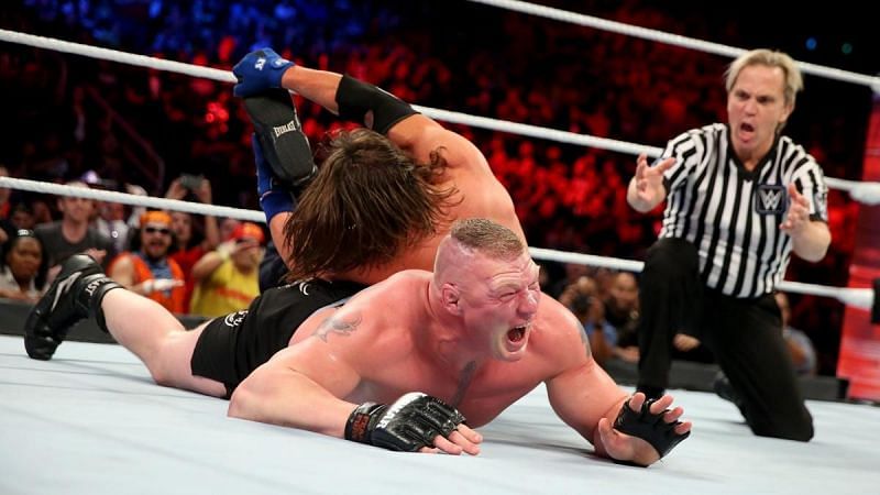 Styles applies the Calf Crusher to Lesnar&#039;s injured leg.