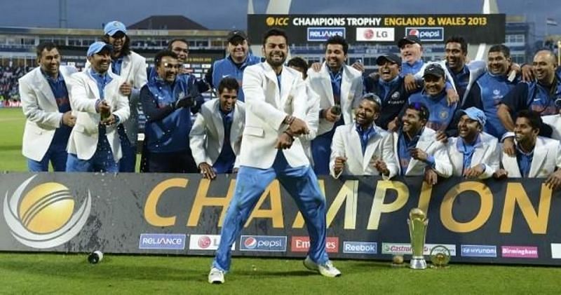 Dhoni (L) enjoys from the end as the team celebrates its 2013 Champions Trophy triumph