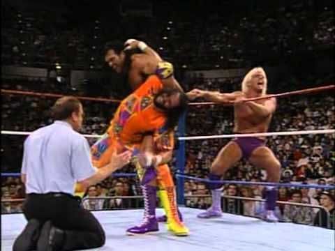 Ric Flair taunts the crowd as Razor Ramon traps the Macho Man in an abdominal stretch.