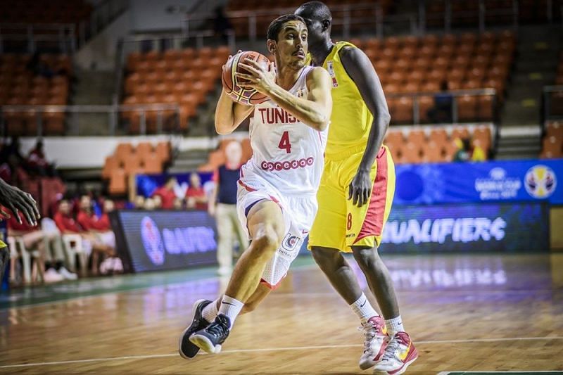 Omar Abada (4) of Tunisia drives past a Chad defender in the easy 61-point win.
