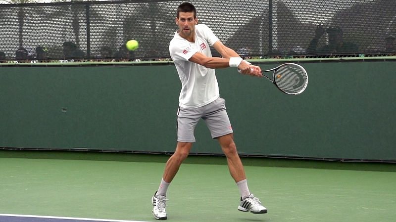  As the Serbian gets into position, he makes sure that the strings of his racket points sideways and therefore when he moves the racket forward to contact the ball, the racket face will automatically be vertical.