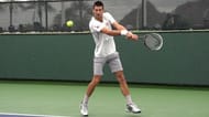 As the Serbian gets into position, he makes sure that the strings of his racket points sideways and therefore when he moves the racket forward to contact the ball, the racket face will automatically be vertical.