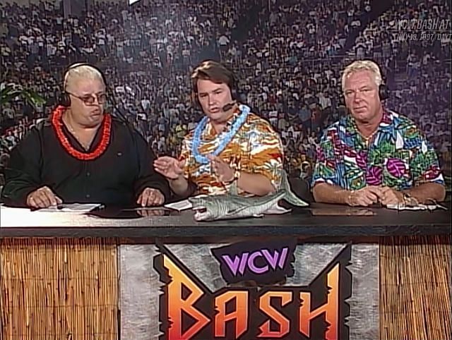 Dusty Rhodes calls the action with Tony Schiavone and Bobby Heenan