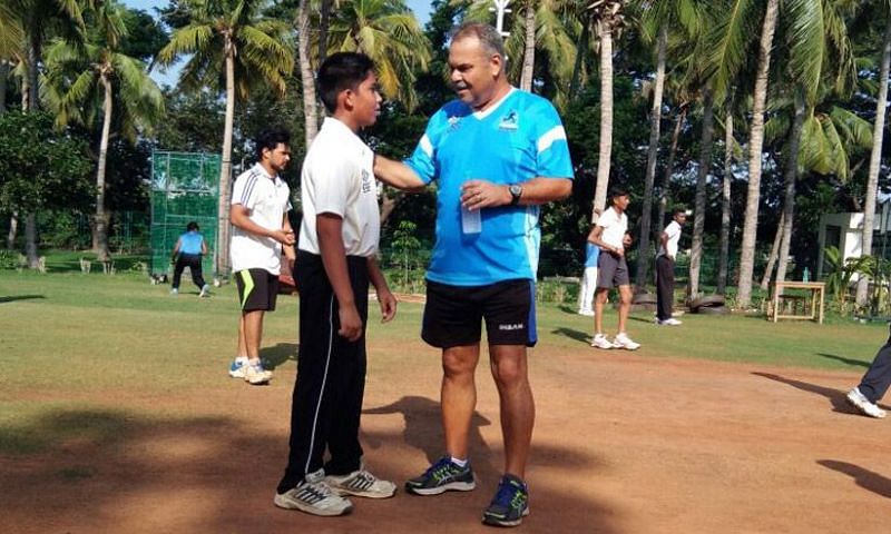 Dav Whatmore interacts with a kid at the Whatmore Cricket Academy
