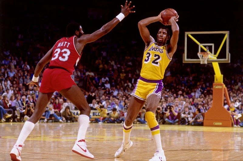 Calvin Natt (left), Magic Johnson (with the ball)