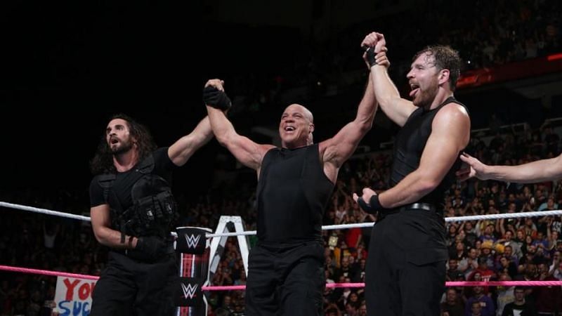 Kurt Angle in the ring with Dean Ambrose and Seth Rollins
