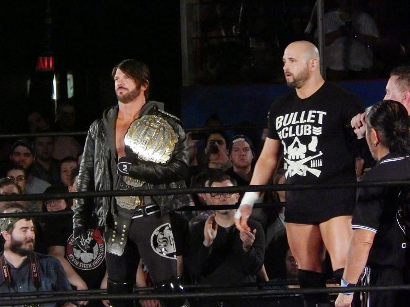 AJ Styles as the IWGP Heavyweight Champion, with Karl Anderson as part of the Bullet Club