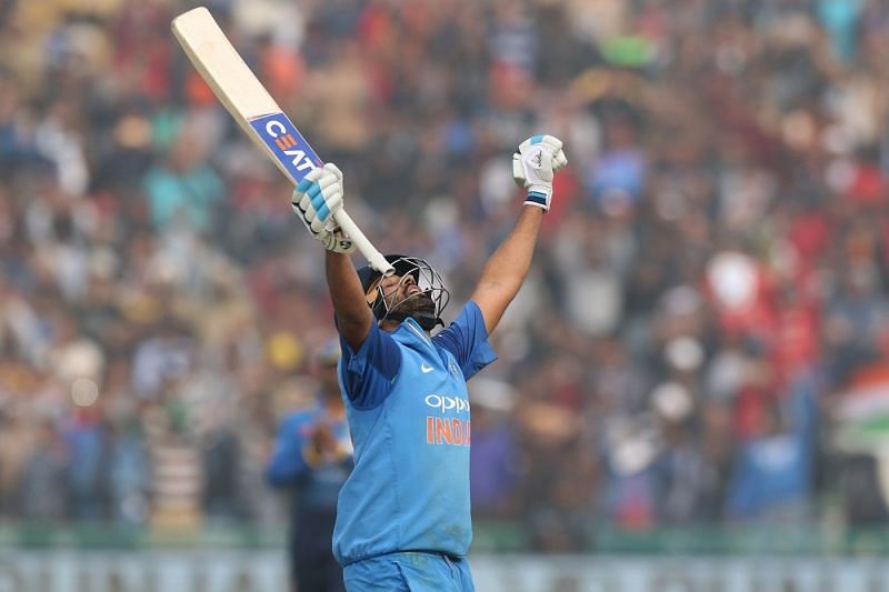 Rohit Sharma raises his bat after scoring his third double hundred