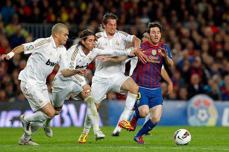 Messi dribbling past three Real Madrid players. Image courtesy SI.com