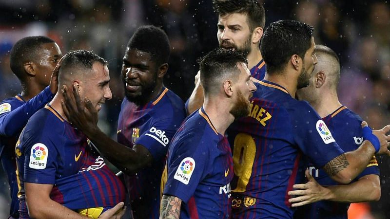 Barcelona players celebrate their goal against Sevilla