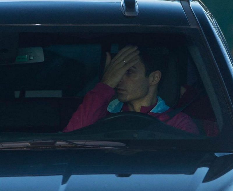  City coach Mikel Arteta covers his face while arriving at training yesterday to hide the cut. credit: thesun.co.uk