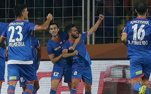 Coro (centre) celebrates his hat-trick with his teammates