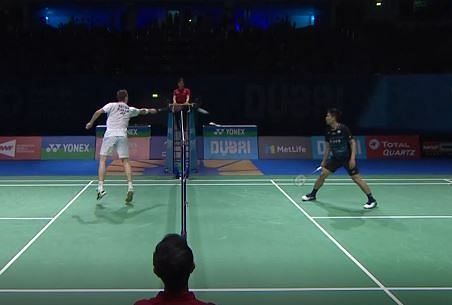 Axelsen touching the net with 