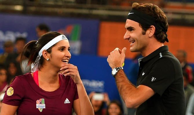 Sania and Roger Federer share a light moment during an ITPL match  