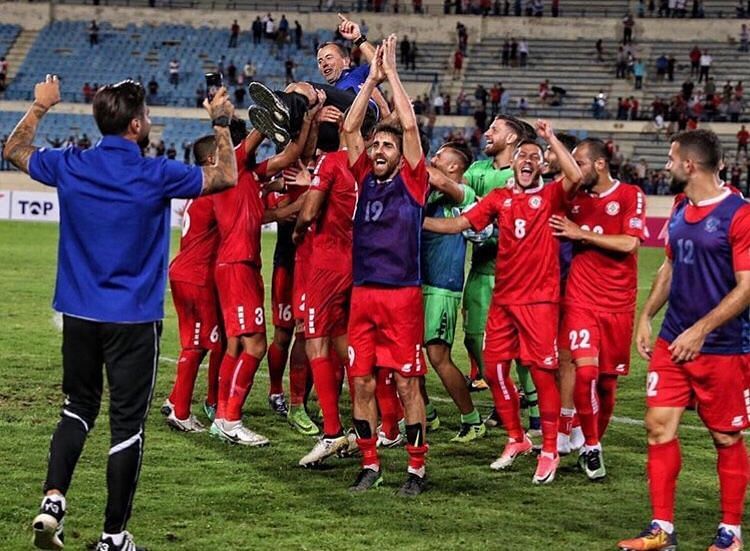 Lebanese players celebrate Asian Cup qualification with coach Miodrag Radulovic. Photo: Lebanon FA